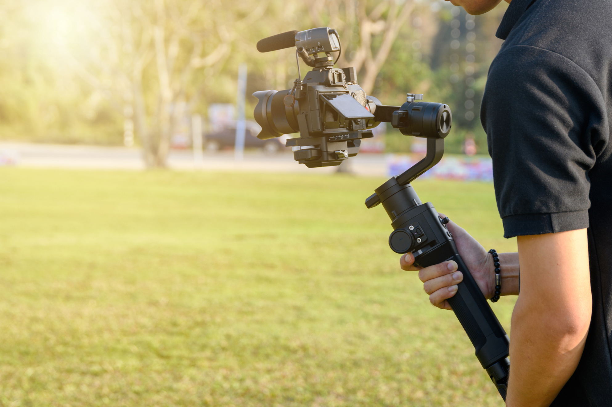 Professional videographer with camera on gimbal stabilizer for t